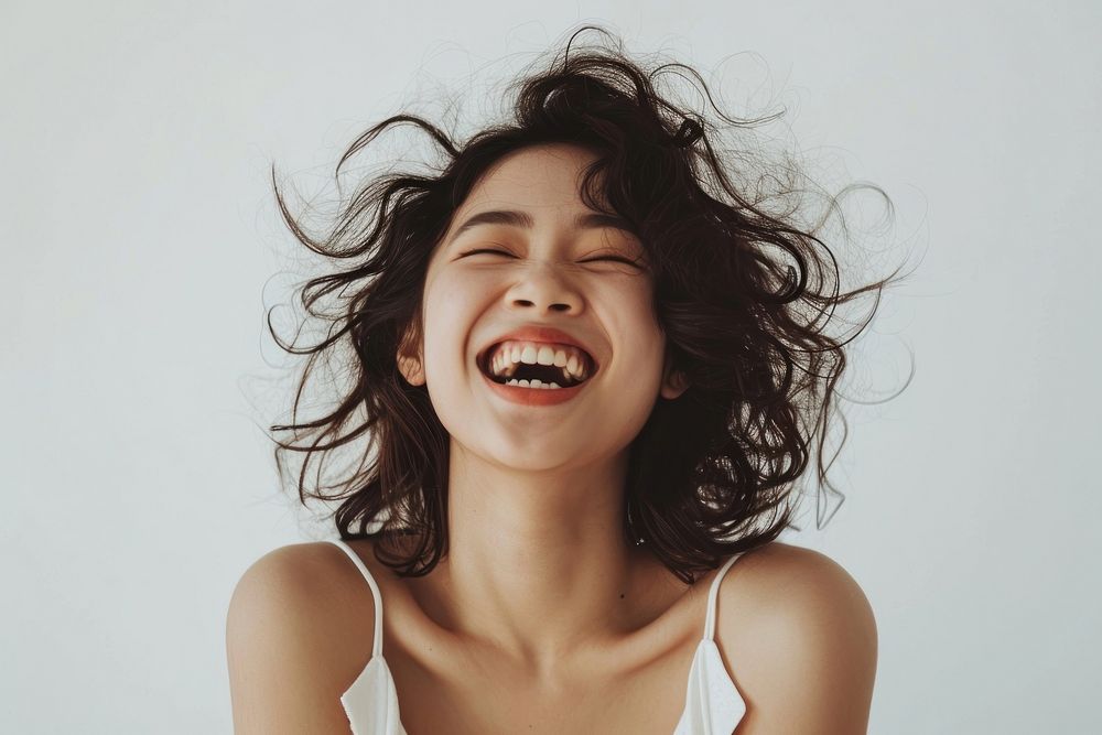 Asian woman with white top laughing smile adult face.