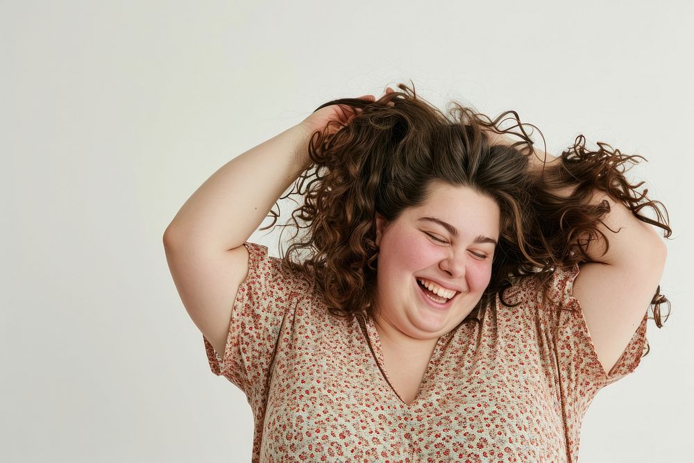 Chubby woman tying hair laughing portrait smile.