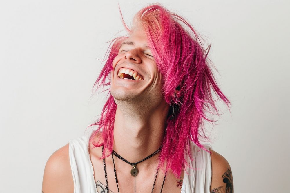 Gay man with white top laughing adult pink hair.