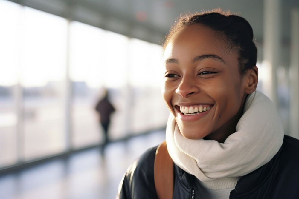 African-American woman smiling at airport adult smile architecture.