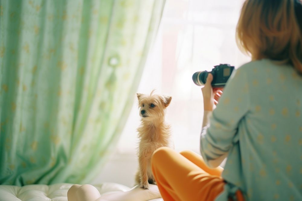 A woman taking a photo of a dog photography mammal animal. AI generated Image by rawpixel.