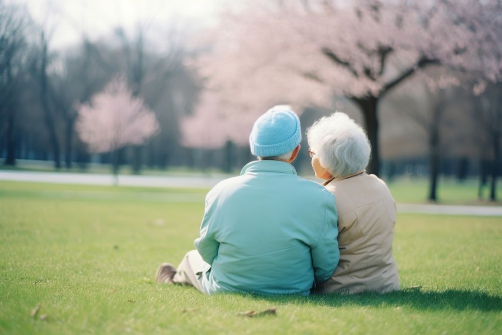 Elderly couple sitting in the park together outdoors nature plant. AI generated Image by rawpixel.