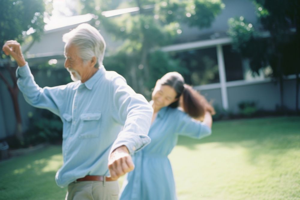 Two couple elder dancing in the backyard motion adult plant. AI generated Image by rawpixel.