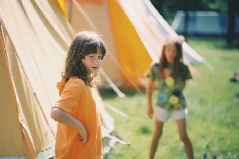 A kids camp outdoors camping grass. 