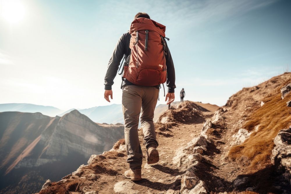 Man hiking on mountain with backpack backpacking footwear adult.