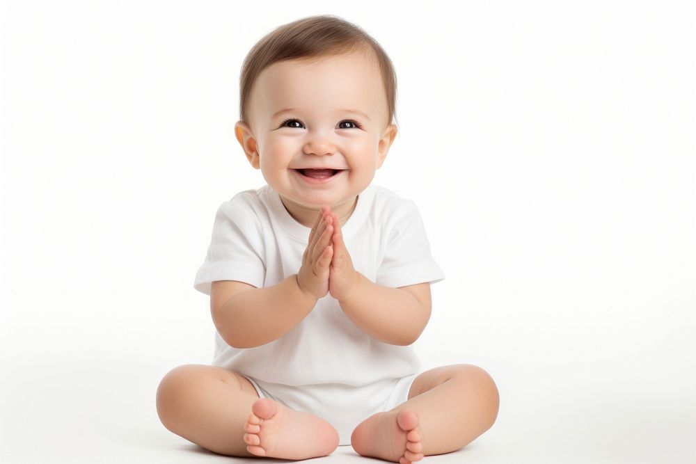 Cute happy white baby sitting and clapping hands portrait white background cross-legged.