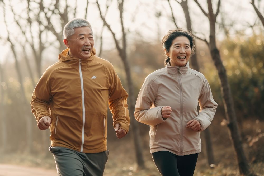 Elderly chinese woman and man running in the park jogging adult togetherness. AI generated Image by rawpixel.