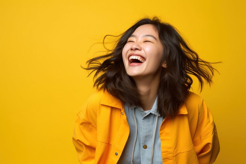 Laughing young asian woman adult joy excitement.