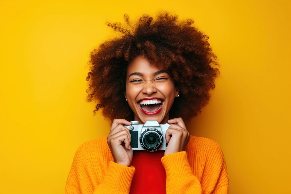 Smiling young black woman laughing camera smile.