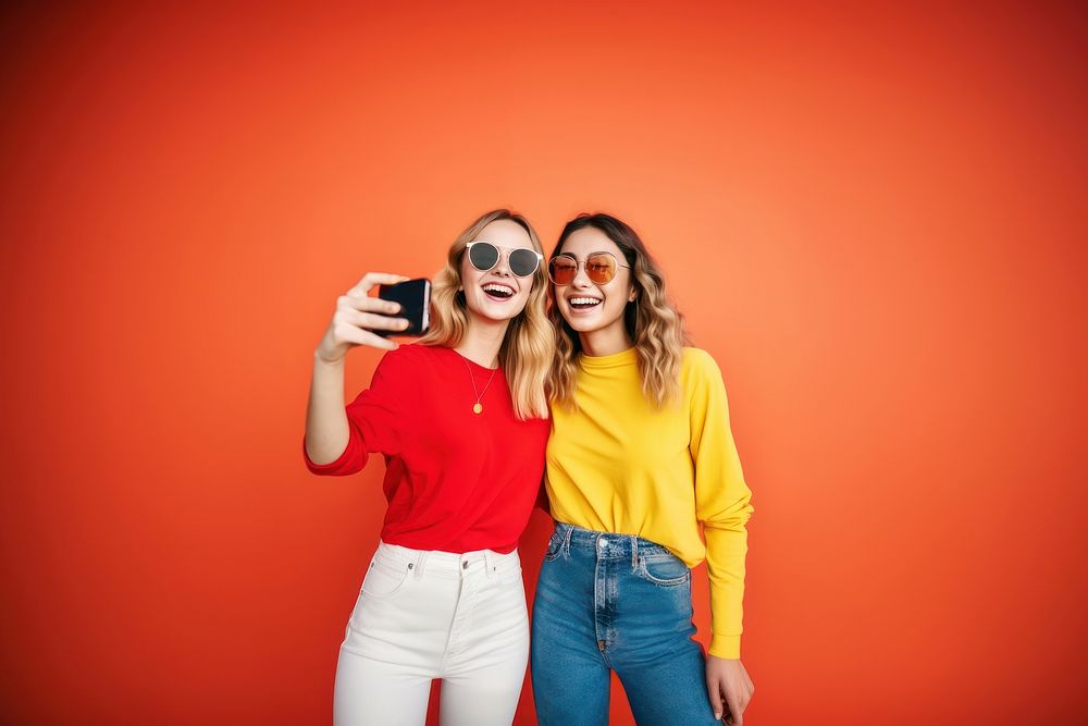 Two playful women taking selfie photography laughing adult.