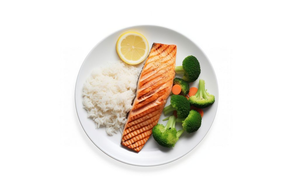 A salmon steak with rice and boiled vegetables as a side an a slice of lemon on the white plate food seafood meal.