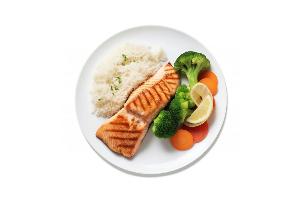 A salmon steak with rice and boiled vegetables as a side an a slice of lemon on the white plate food seafood white…