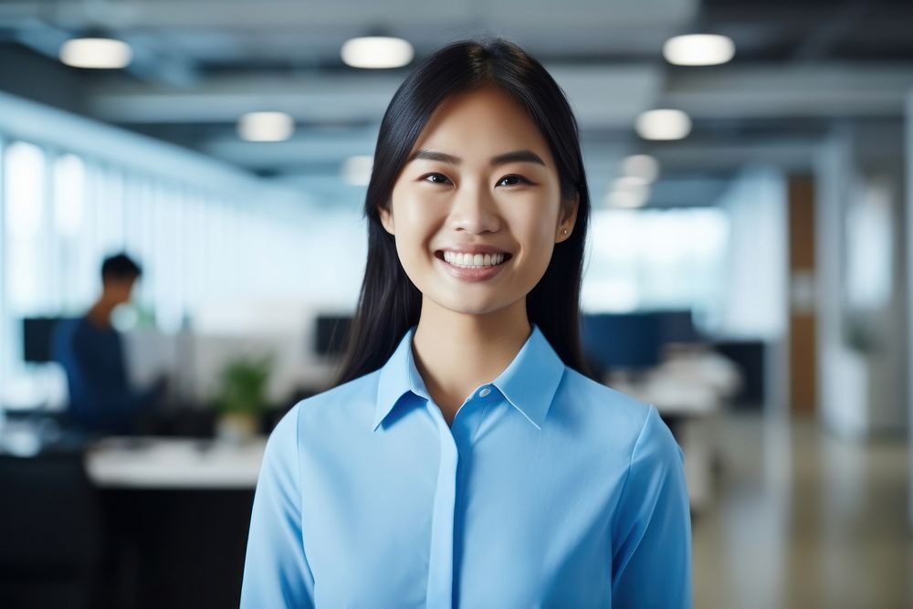 An asian woman smile in the office adult shirt blue. AI generated Image by rawpixel.
