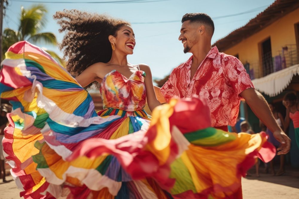 Latina and Latino in colorful costumes dancing celebration celebrating laughing.