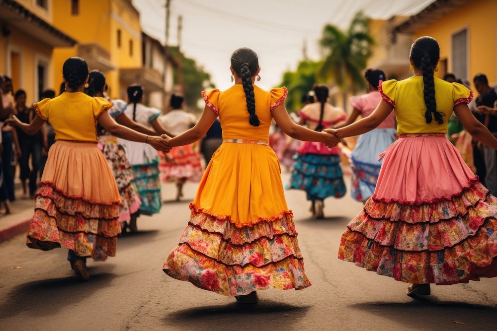 Mexican women dancers dressed with colorful skirts marching down a street in the country celebration dancing yellow.