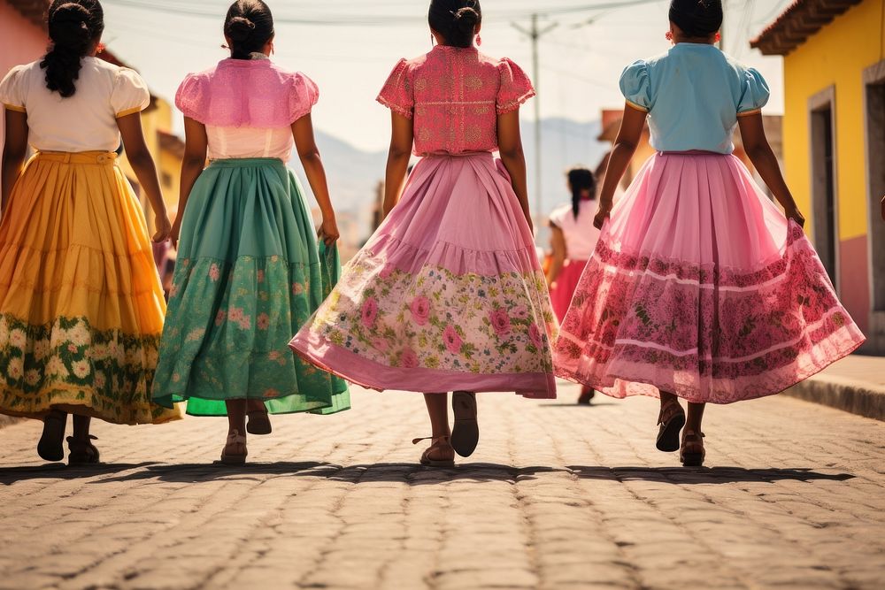 Mexican women dressed with colorful skirts marching down a street in the country celebration dancing adult.