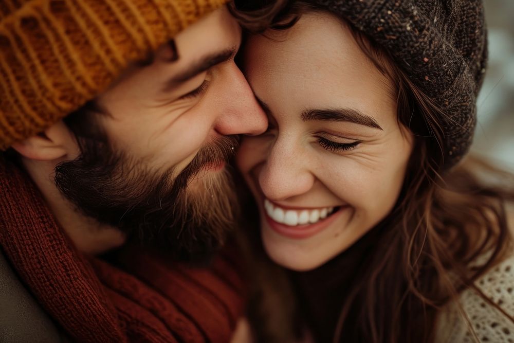 Woman kissing her smiling boyfriend on a cheek laughing adult happy.