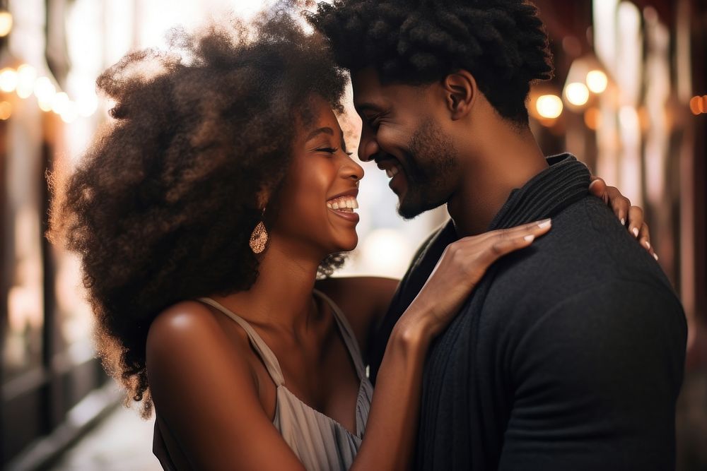 Black woman kissing her smiling boyfriend on a cheek happy affectionate togetherness.