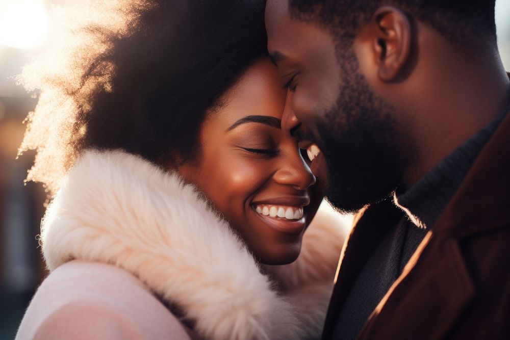 Black woman kissing her smiling boyfriend on a cheek portrait adult happy.