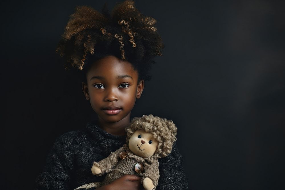 African student holding doll portrait child photo.