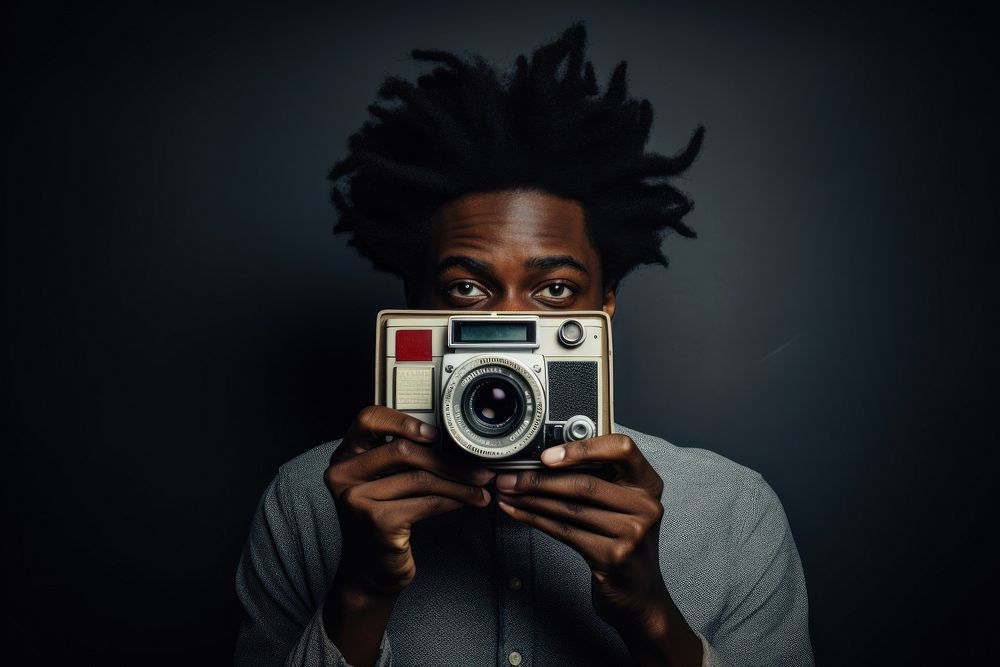 African student holding polaroid camera portrait photo photographing.