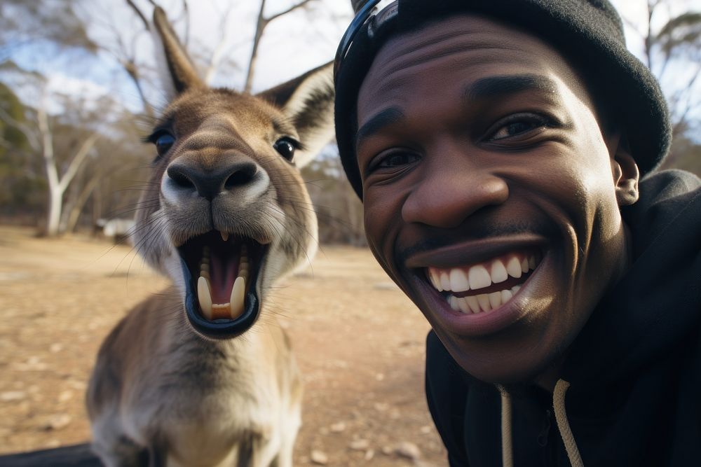 Kangaroo and young black man animal portrait smiling.