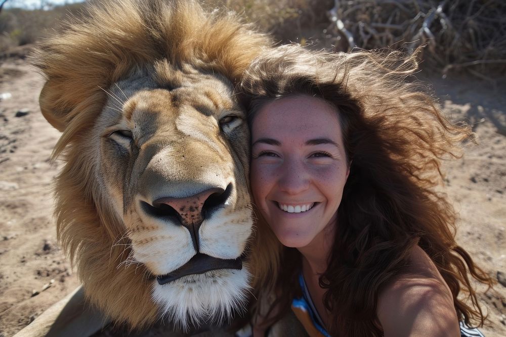 Lion and woman animal portrait outdoors.