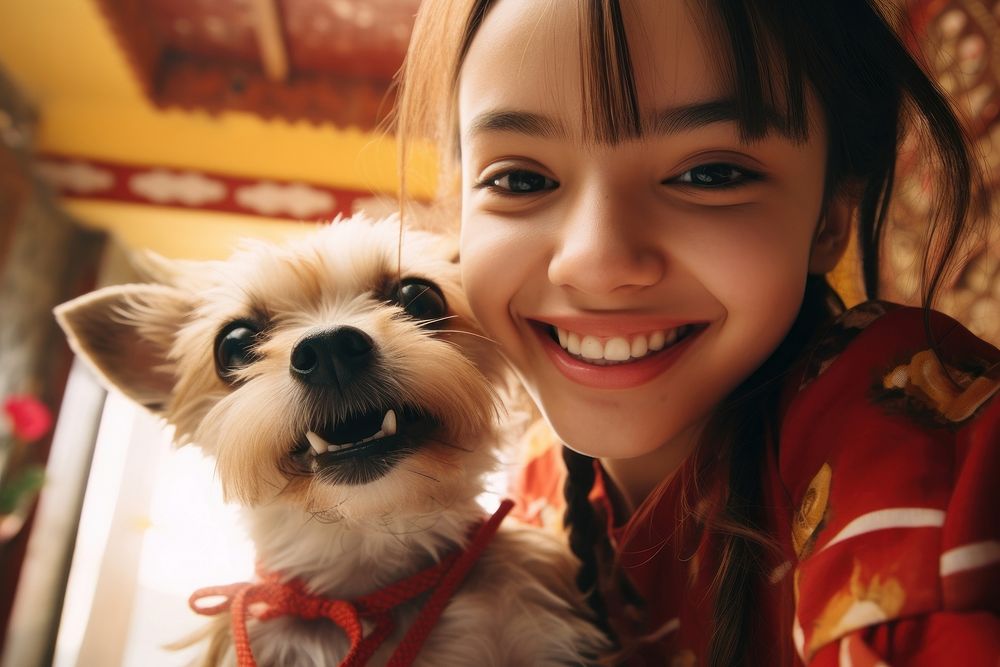 Dog and young mexican girl animal portrait smiling.