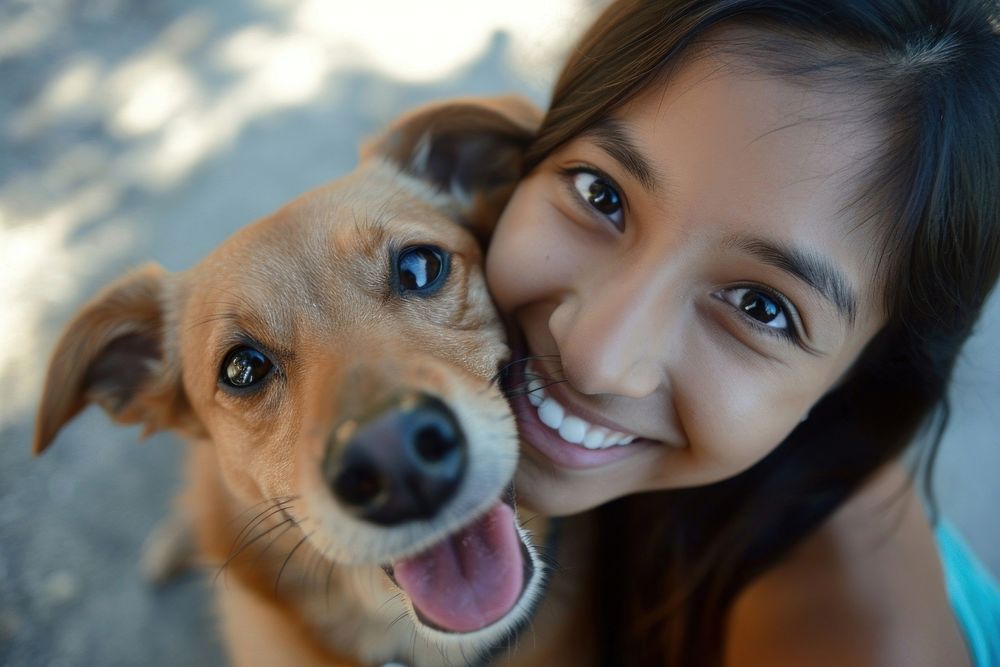 Dog and young mexican girl animal portrait smiling.