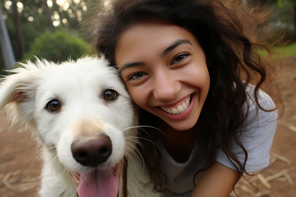 Dog and young mexican girl animal portrait smiling.