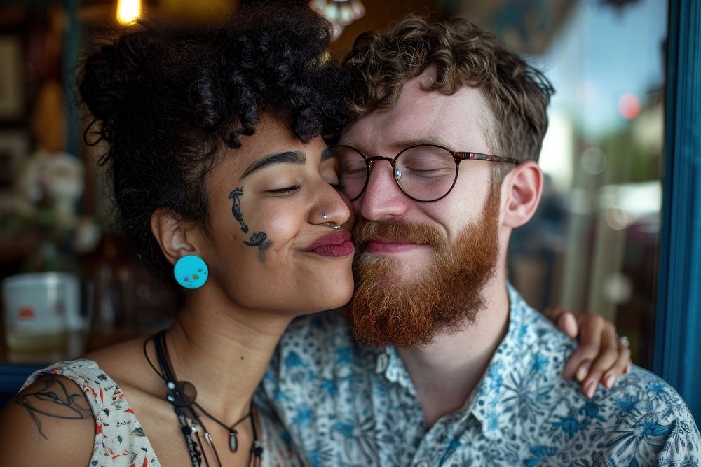 Woman with blue earring kissing portrait glasses jewelry.