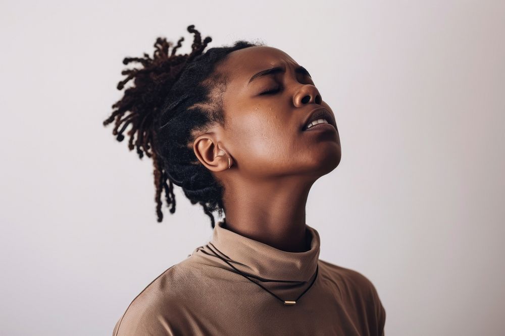 Black woman having difficulty in breathing contemplation dreadlocks hairstyle.