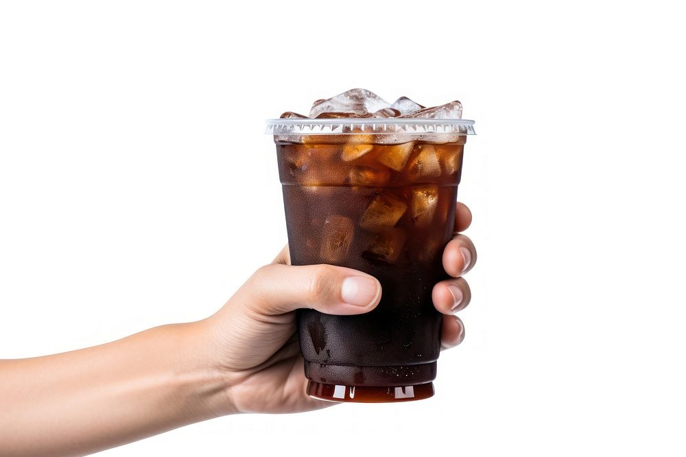 Hand holding a cup of iced black coffee drink glass soda.