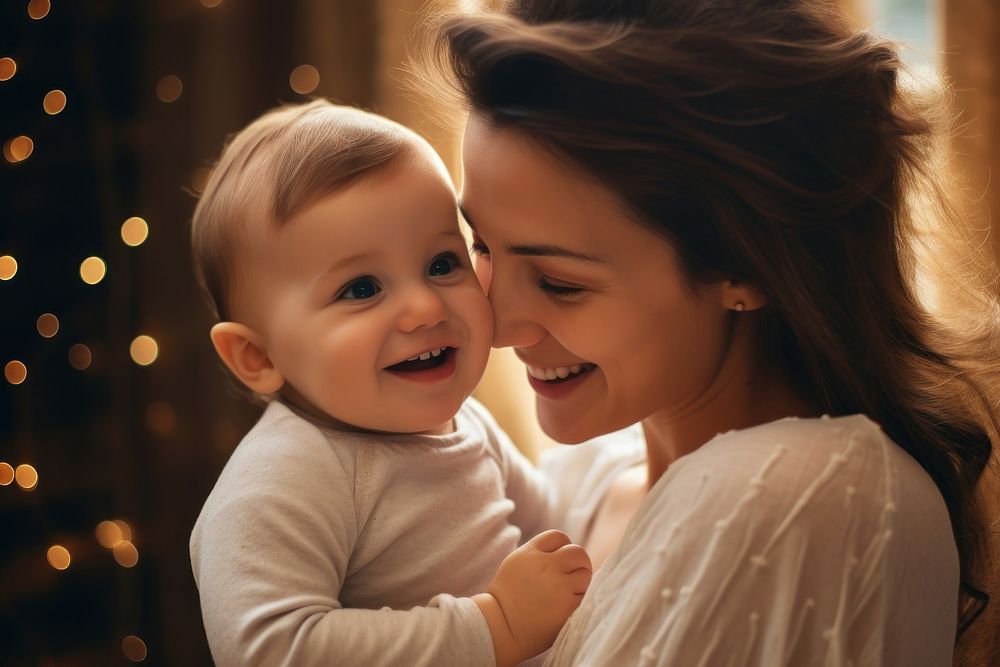 Baby laughing portrait kissing.