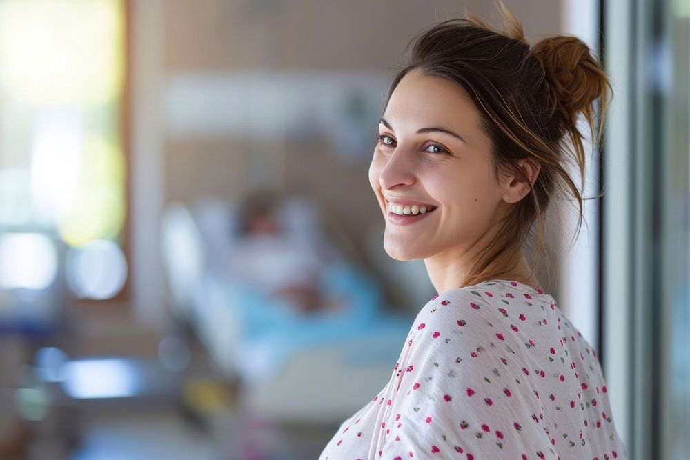 Happy pregnant woman in a hospital smile adult contemplation.