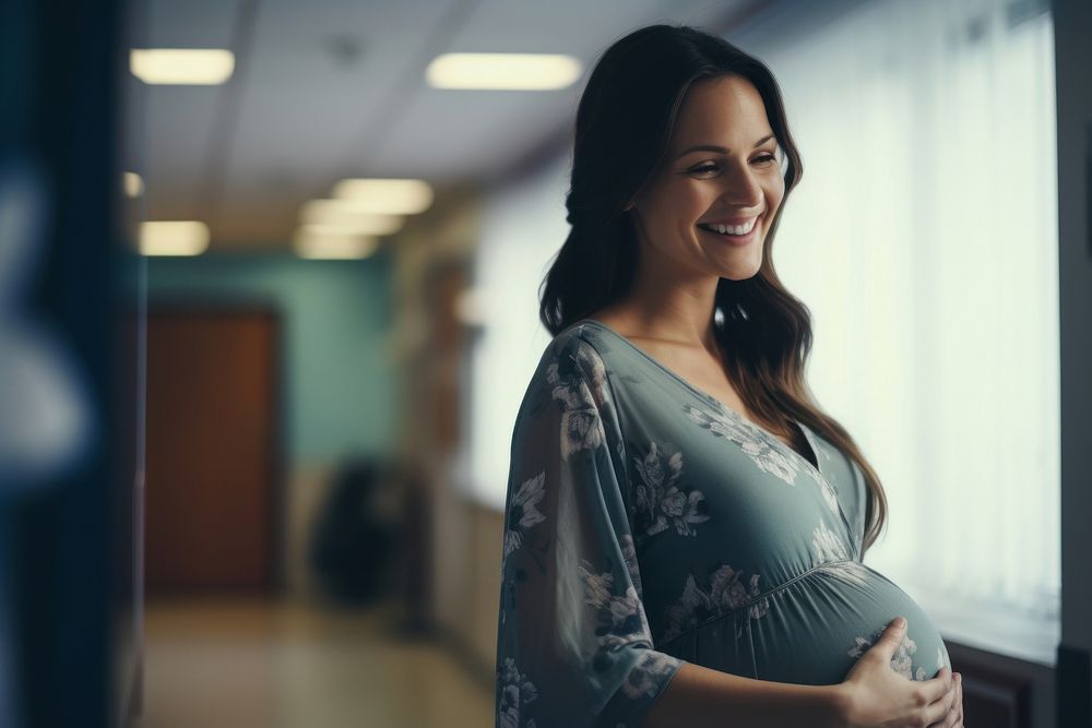 Happy pregnant woman in a hospital smile adult anticipation.