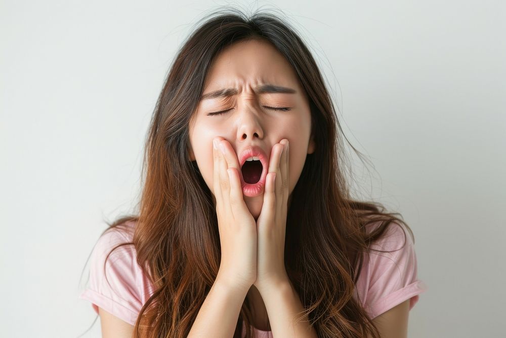 Asian girl yawning frustration overworked.