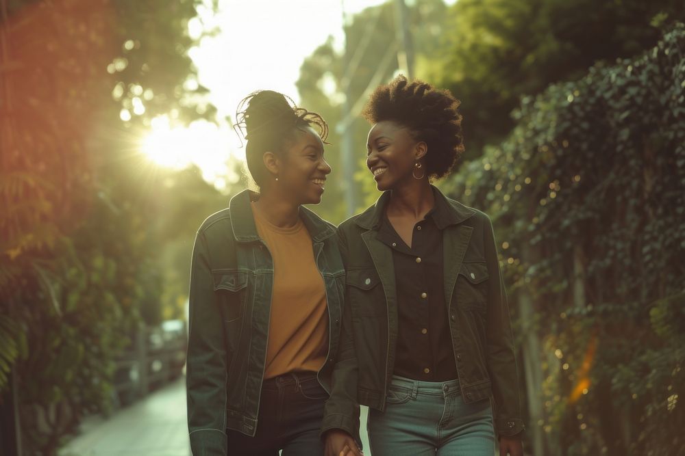 Black lesbian couple holding hands smiling adult togetherness.