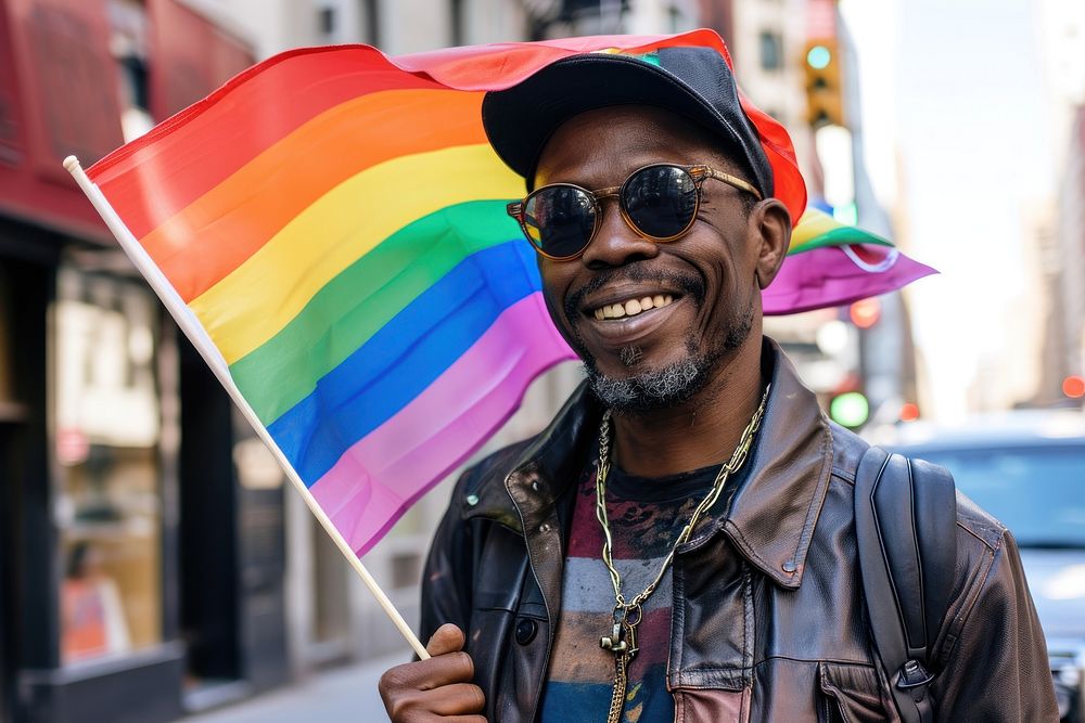 Black man holding pride flag smiling parade adult.