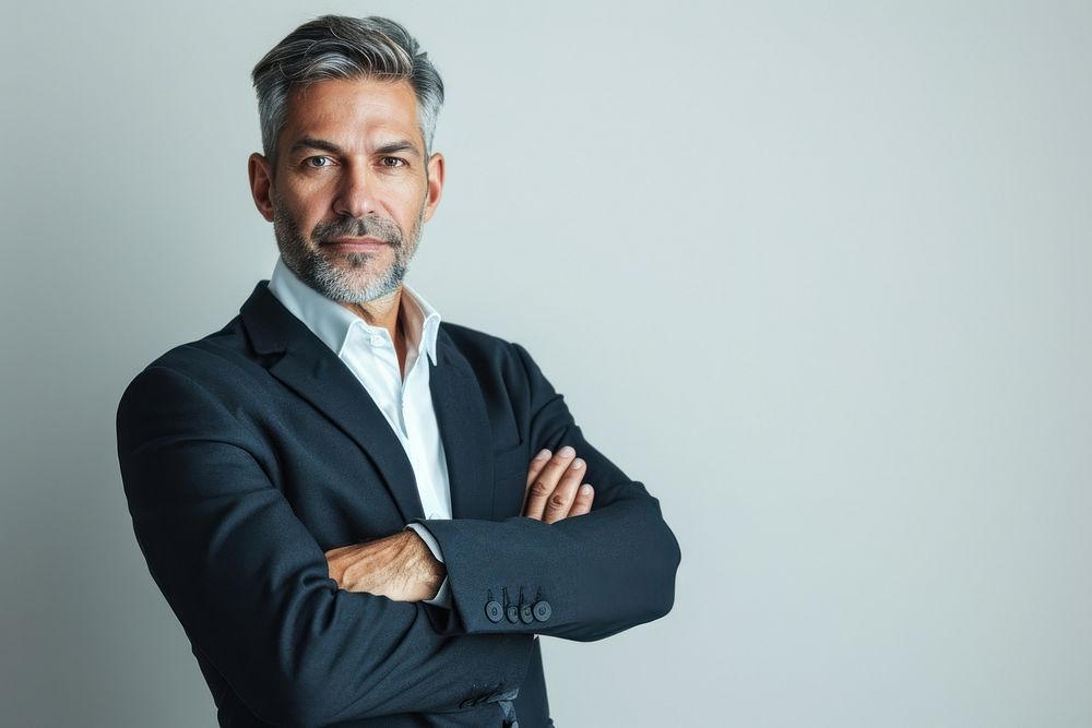 Good-looking middle-aged businessman with arms crossed portrait adult photo.