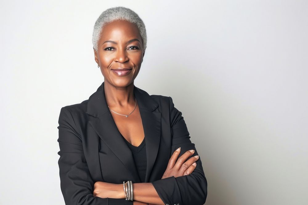 Good-looking middle-aged black businesswoman with arms crossed portrait adult smile.