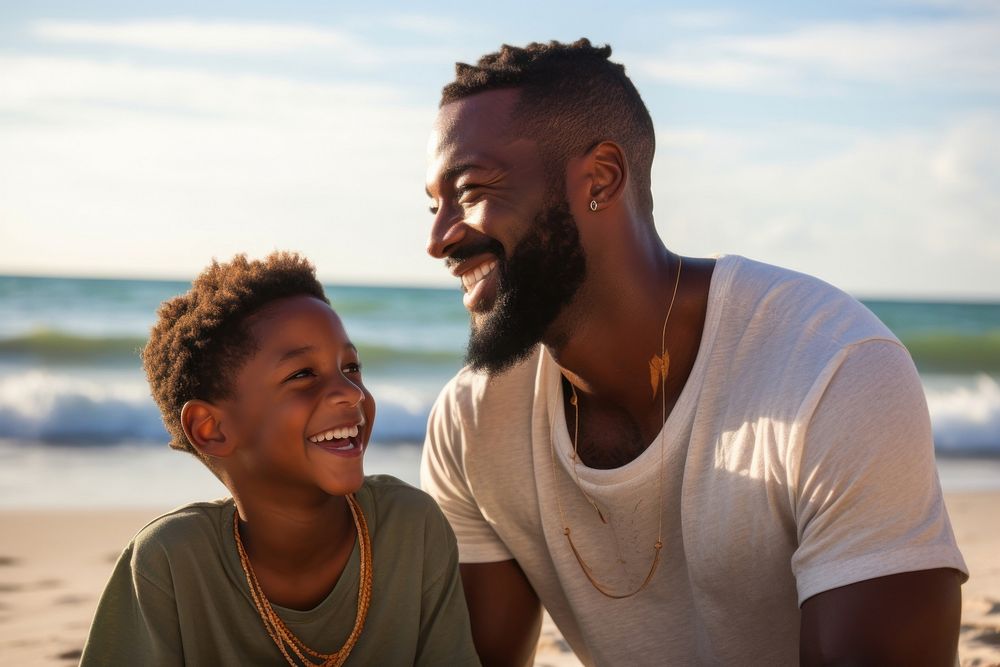 Black father and a son beach photography laughing.