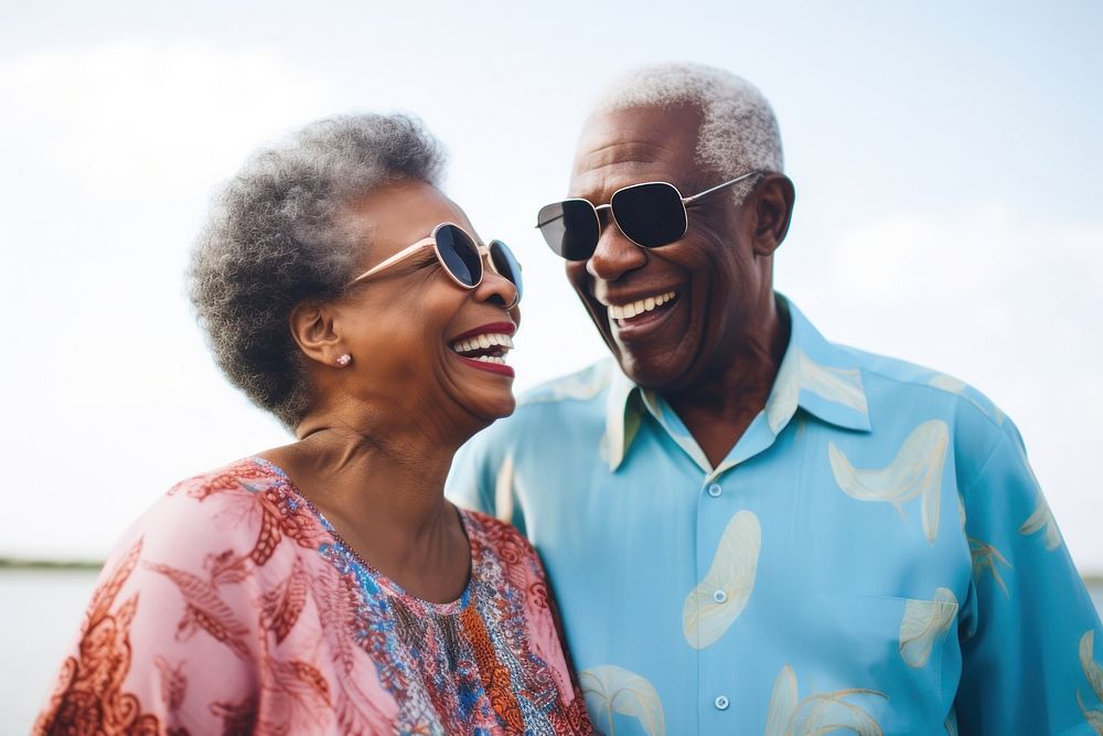 Old black couple laughing glasses smiling.