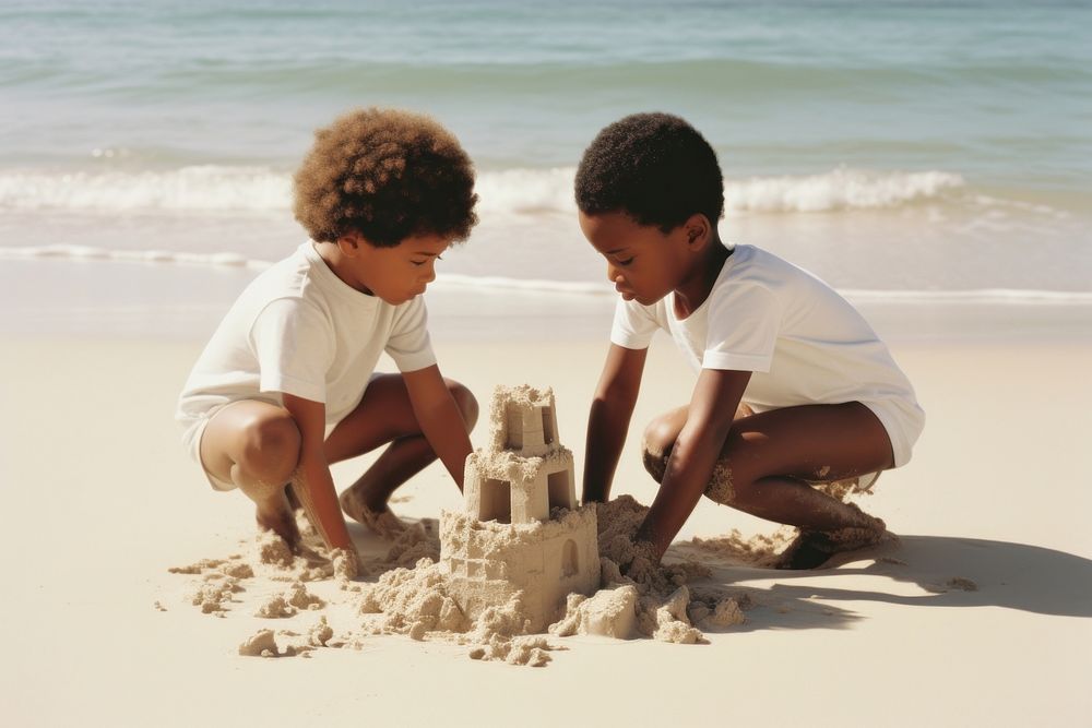 Black kids building sand castle outdoors summer beach.
