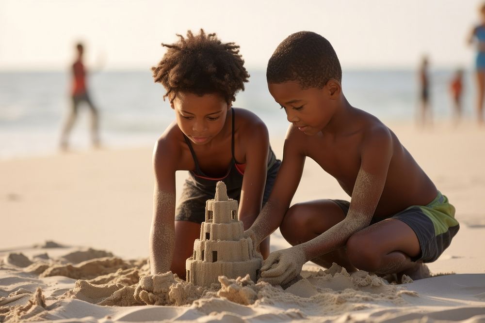 Black kids building sand castle outdoors summer beach.