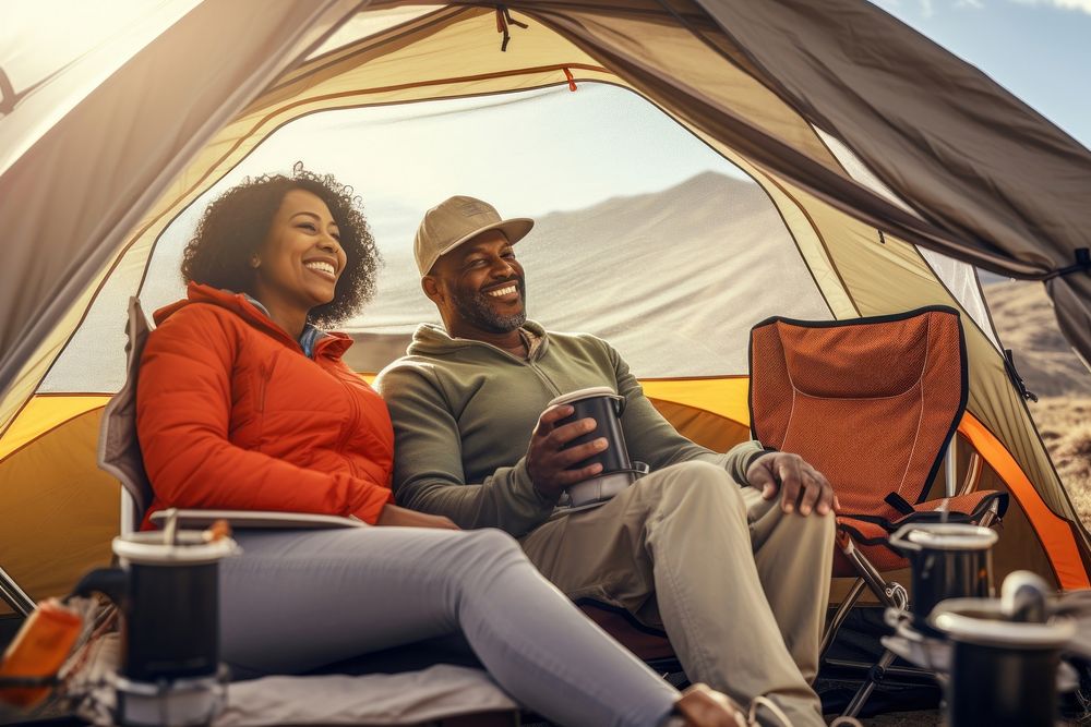 Middle age african american couple camping tent outdoors.