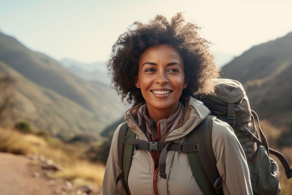 Middle-aged African American female backpacker backpacking mountain walking.