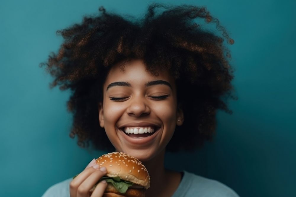 African American girl food laughing cheerful.