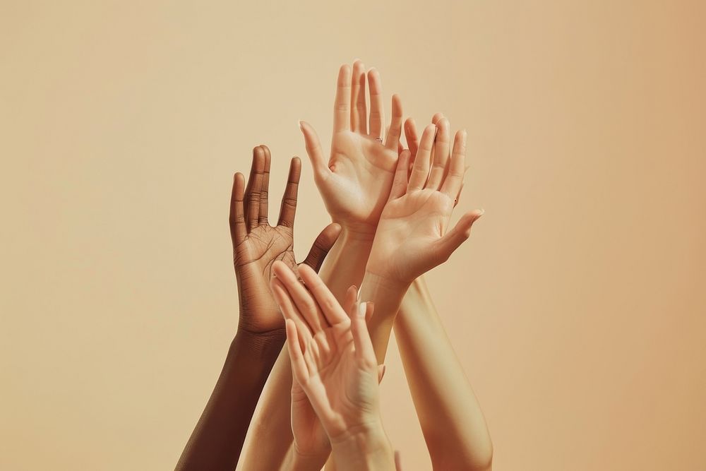 A group of hands reaching up and holding on to each other finger adult gesturing.