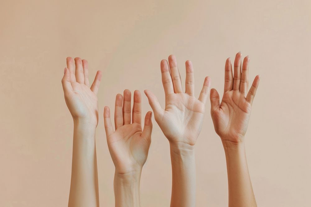 A group of hands reaching up and holding on to each other finger skin gesturing.